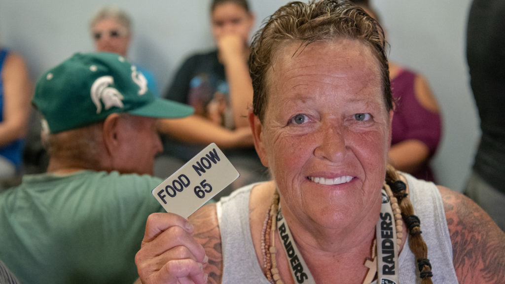 Woman with tats holding number617
